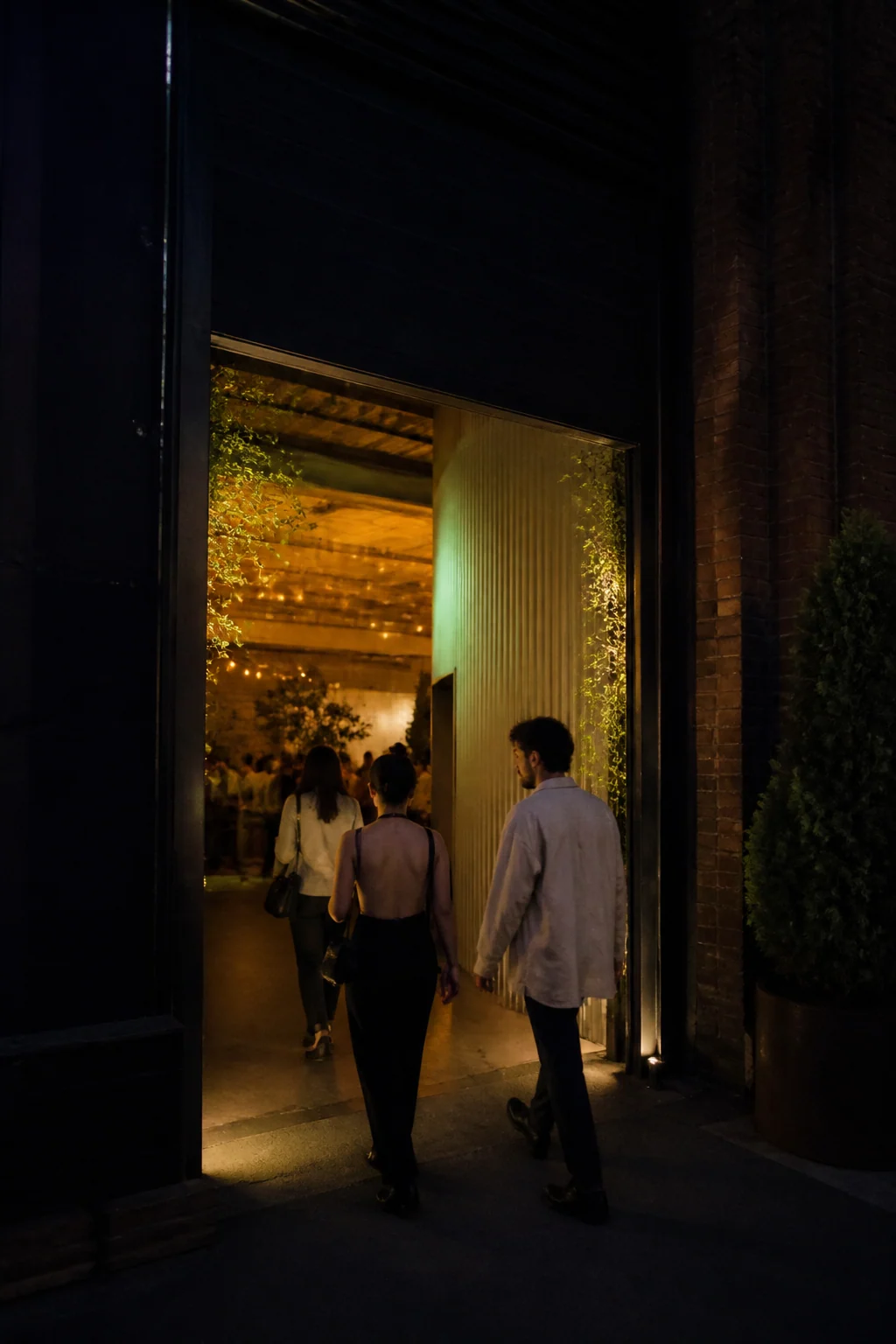 Two guests arriving at a warmly lit venue